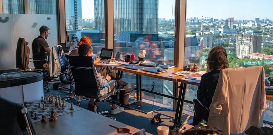 A team reviewing a project workflow around a shared desk